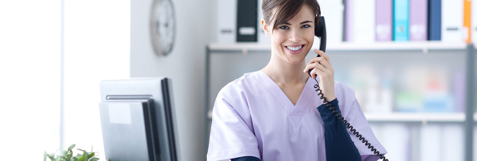 A female receptionist talking over the phone